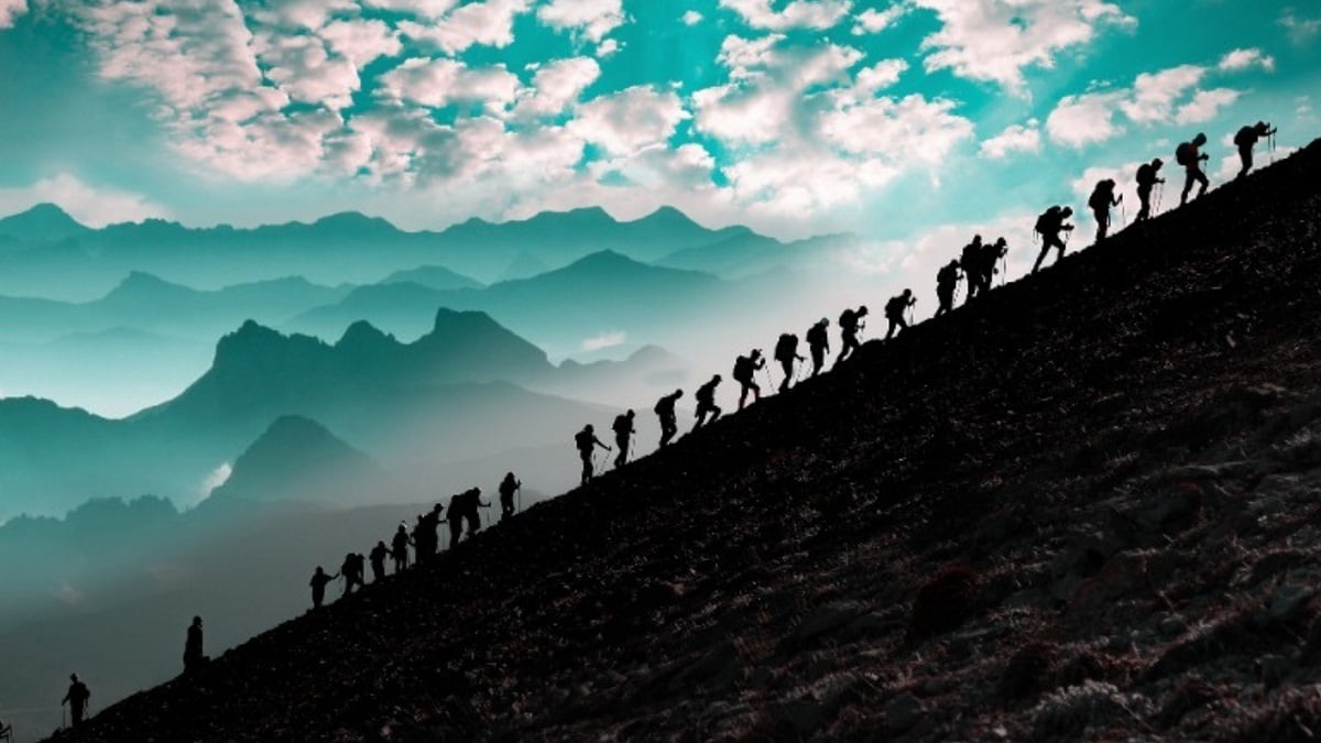 A team of hikers are climbing a mountain.