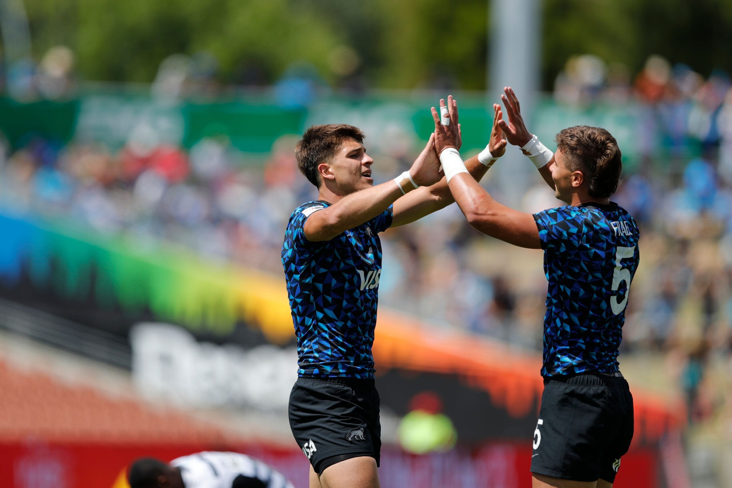 Argentina's Mateo Graziano and Agustin Fraga celebrate the cup quarter final win against Fiji on day two of the HSBC Hamilton Sevens at FMG Stadium Waikato on January 22, 2023