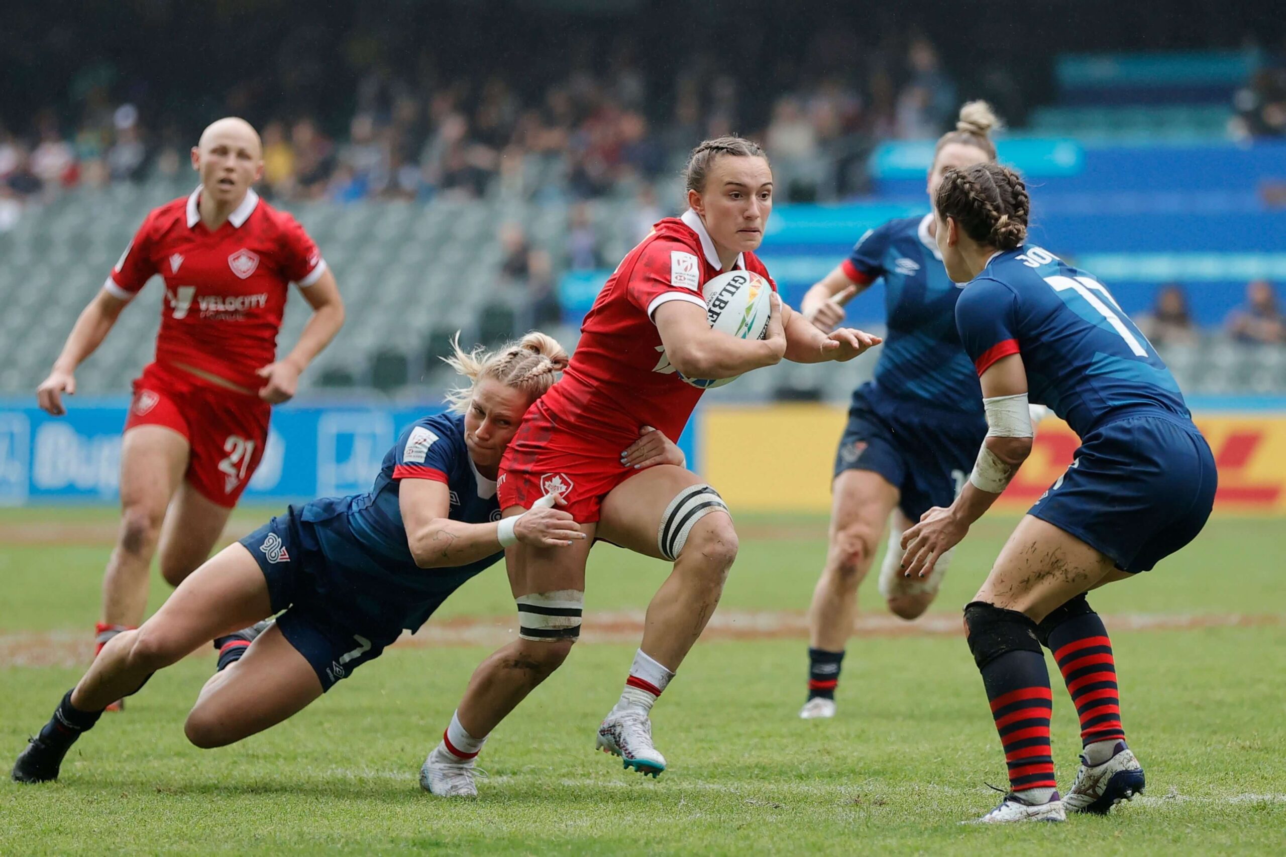 Canada's Krissy Scurfield charges through the Great Britain defense on day one of the Cathay/ HSBC Hong Kong Sevens at Hong Kong Stadium on 31 March, 2023 in Hong Kong, China.