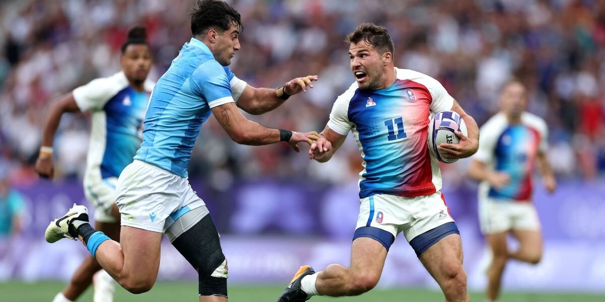 Antoine Dupont #11 of Team France is challenged by Bautista Basso #5 of Team Uruguay during the Men's Rugby Sevens Pool C Group match between France and Uruguay