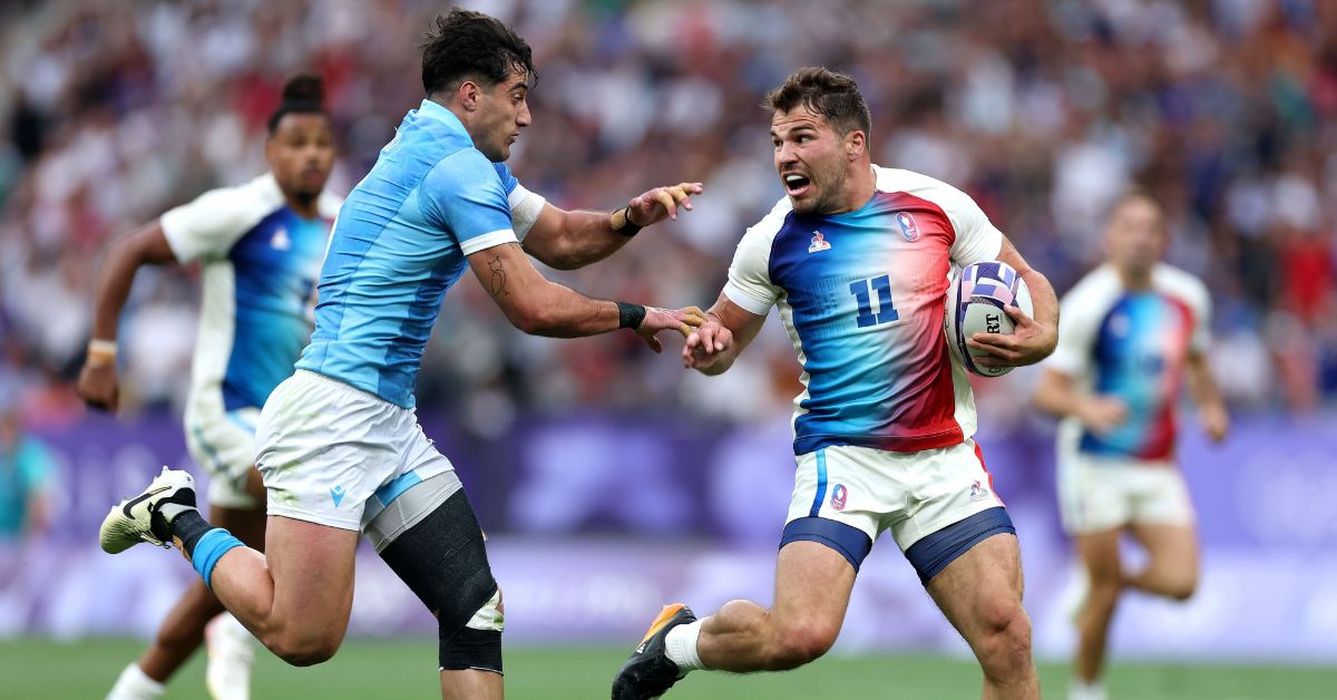 Antoine Dupont #11 of Team France is challenged by Bautista Basso #5 of Team Uruguay during the Men's Rugby Sevens Pool C Group match between France and Uruguay