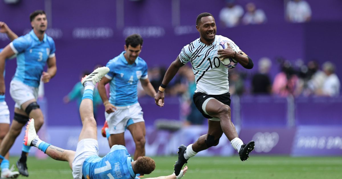 Fiji’s Iowane Teba breaks through the Uruguay defense for a try on day one of the Paris 2024 Olympic Games at Stade de France on 24 July, 2024 in Paris.